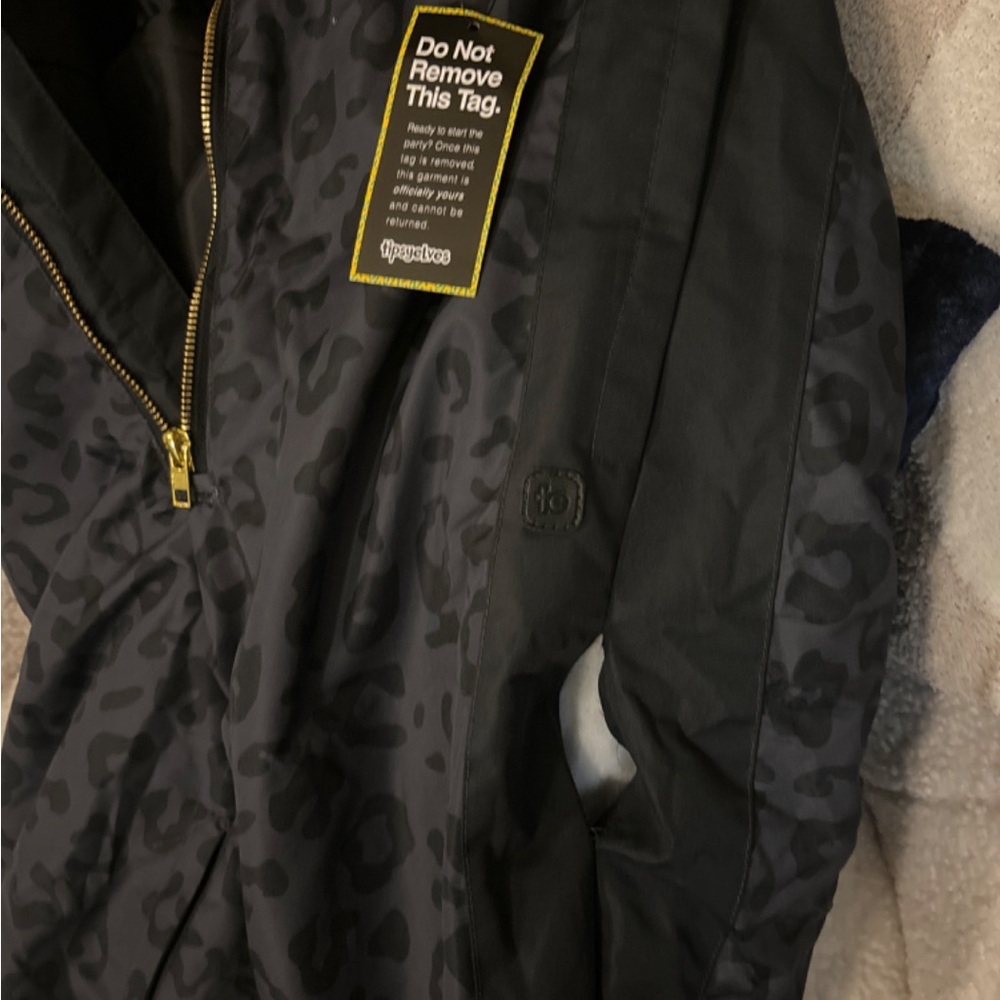 This has never been worn. It came with a rip in the leg. It can be fixed!